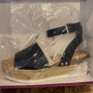 Brand new. Never been out of package. Platform sandal.